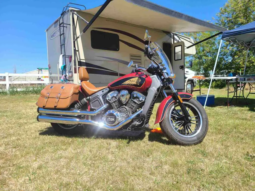 The 2019 Indian Scout pictured in profile. Sunlight gleams from glossy chrome exhaust pipes.