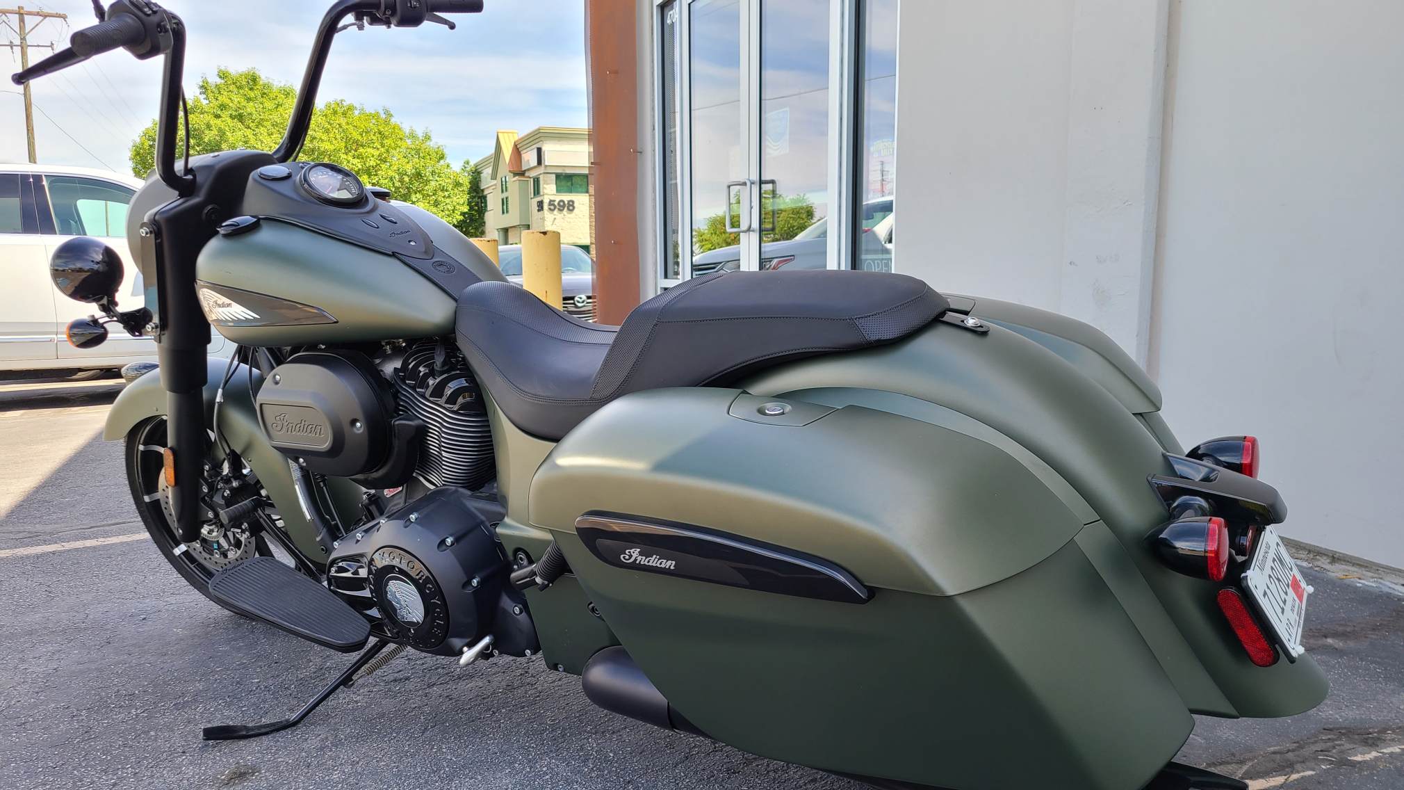 2020 Indian Springfield Dark Horse parked in the shade in a parked right next to the entrance of a building.